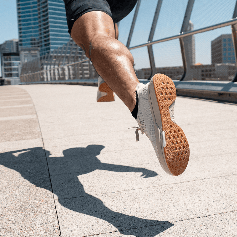 Heel/sole view of man running in shoe 