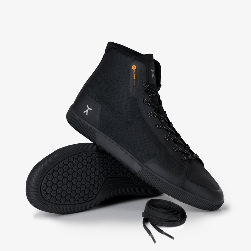 3/4 view of all black high top workout fitness gym power lifting shoes with flux logo on heel and Graphene-Wear orange logo at collar. 