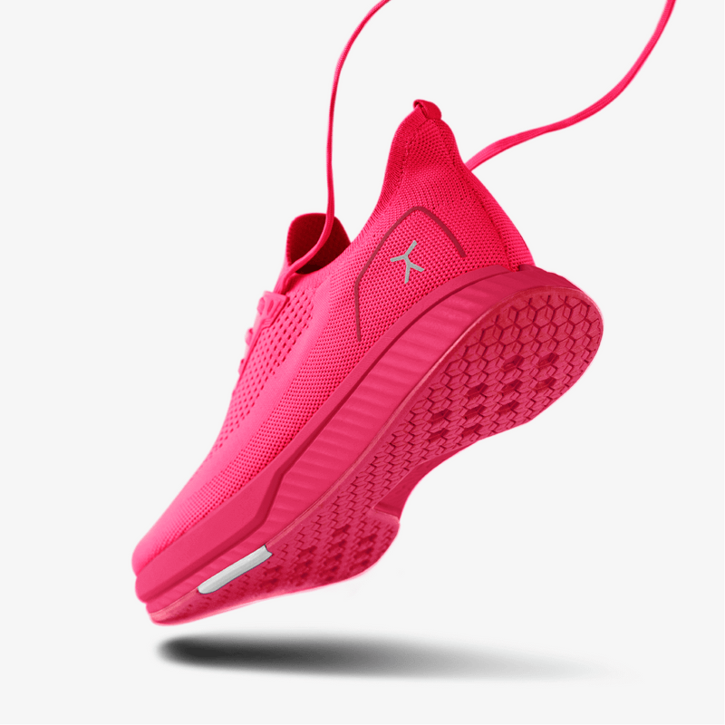 3/4 of heel and outsole of neon pink running shoe 